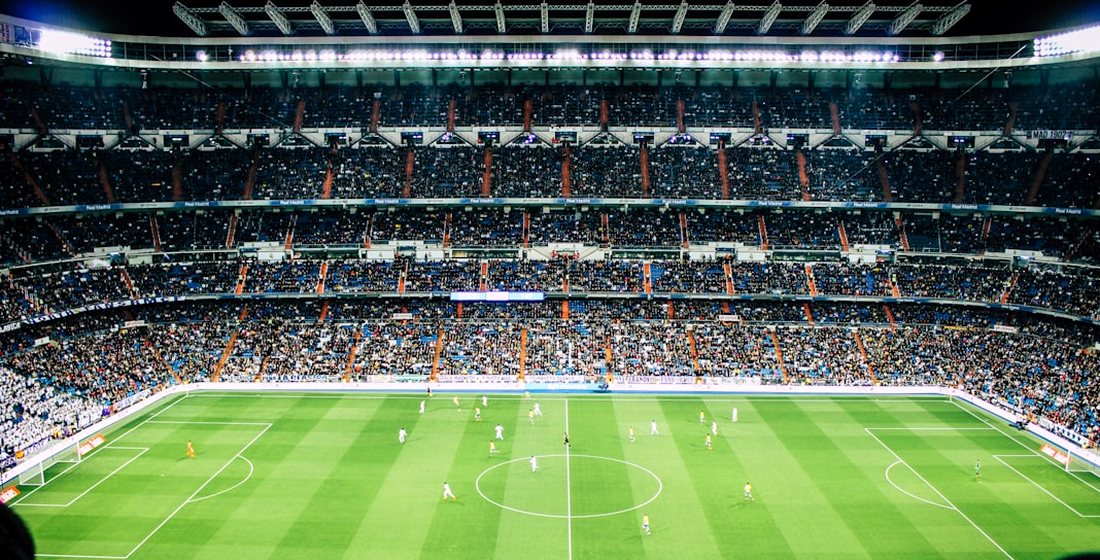 A packed football stadium under floodlights, streamed live in 4K on GreatestIPTV